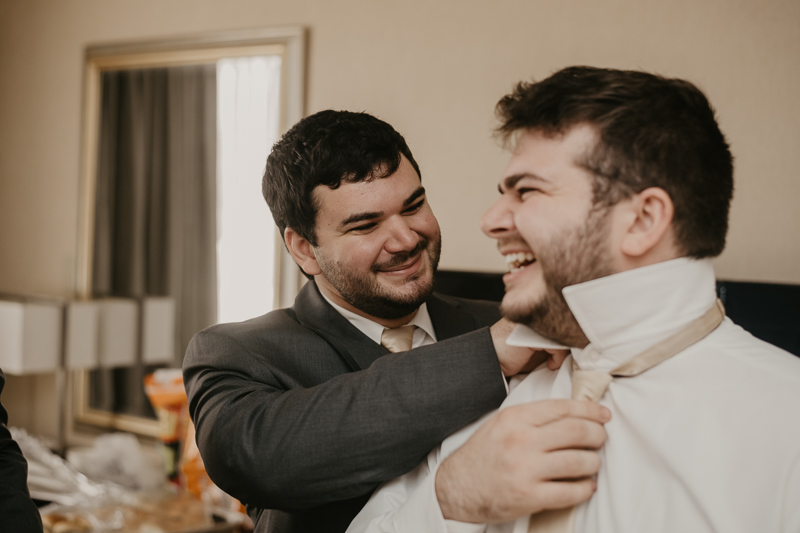 A groom getting ready at the Double Tree Hilton Hotel Baltimore for a Mt. Washington Mill Dye House in Baltimore, Maryland by Britney Clause Photography