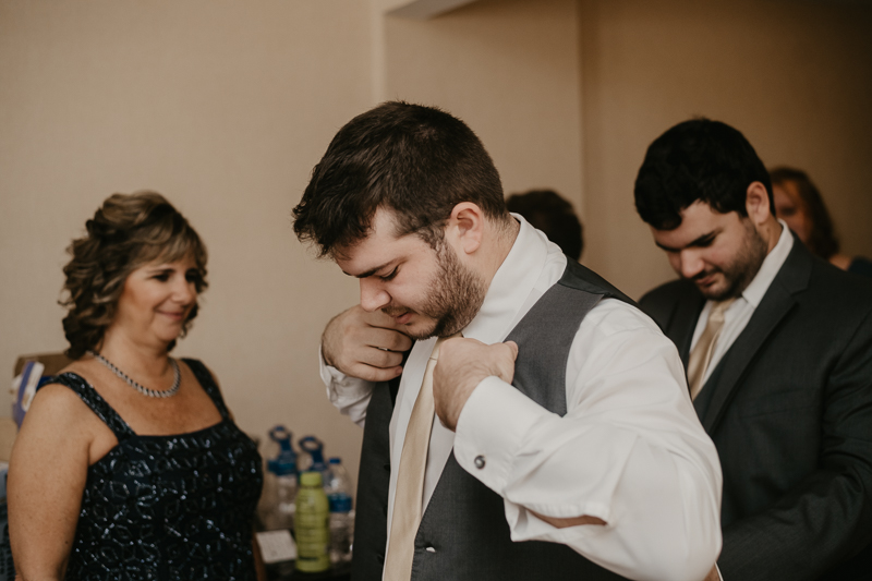A groom getting ready at the Double Tree Hilton Hotel Baltimore for a Mt. Washington Mill Dye House in Baltimore, Maryland by Britney Clause Photography