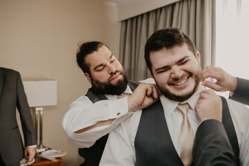 A groom getting ready at the Double Tree Hilton Hotel Baltimore for a Mt. Washington Mill Dye House in Baltimore, Maryland by Britney Clause Photography