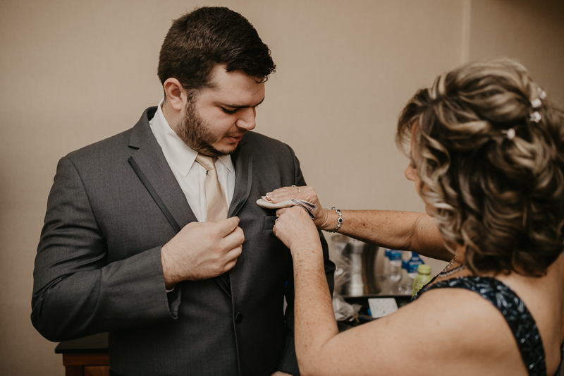 A groom getting ready at the Double Tree Hilton Hotel Baltimore for a Mt. Washington Mill Dye House in Baltimore, Maryland by Britney Clause Photography