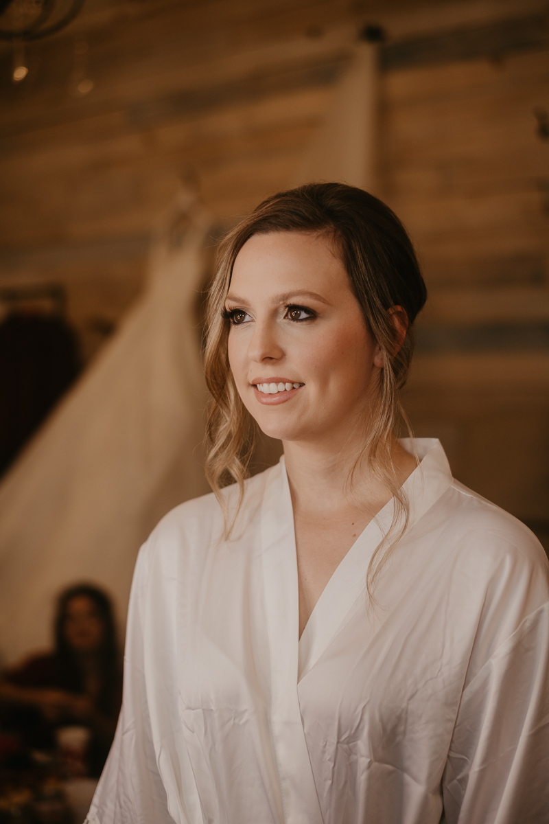 A bride getting ready for her wedding at Kylan Barn in Delmar, Maryland by Britney Clause Photography