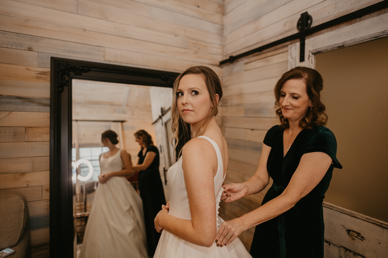 A bride getting ready for her wedding at Kylan Barn in Delmar, Maryland by Britney Clause Photography