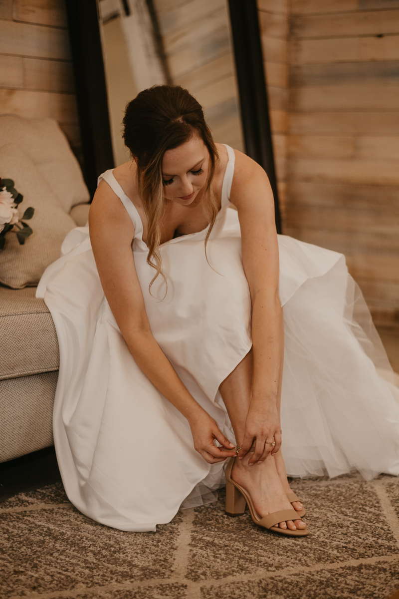 A bride getting ready for her wedding at Kylan Barn in Delmar, Maryland by Britney Clause Photography