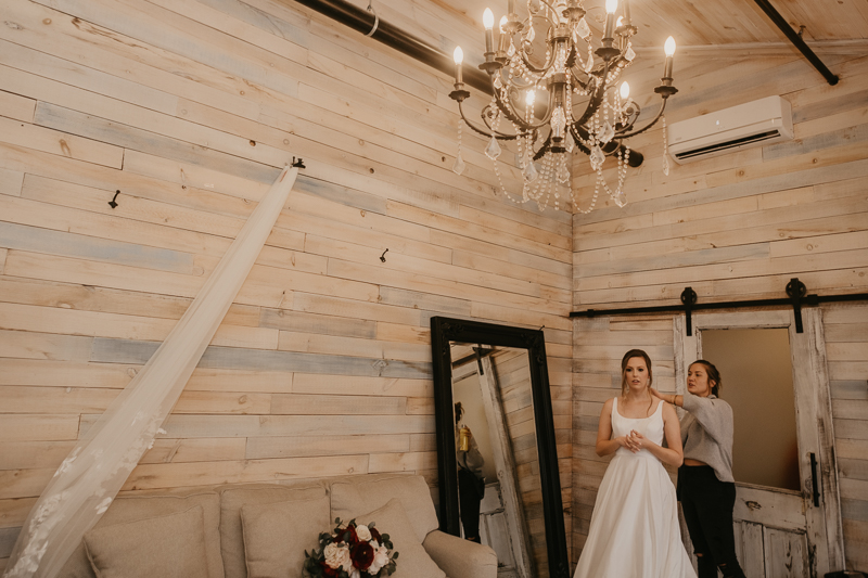 A bride getting ready for her wedding at Kylan Barn in Delmar, Maryland by Britney Clause Photography