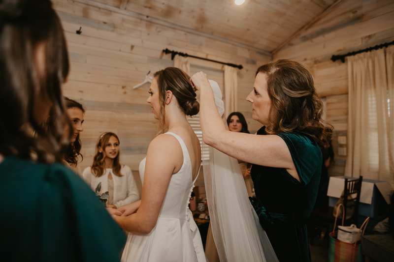 A bride getting ready for her wedding at Kylan Barn in Delmar, Maryland by Britney Clause Photography