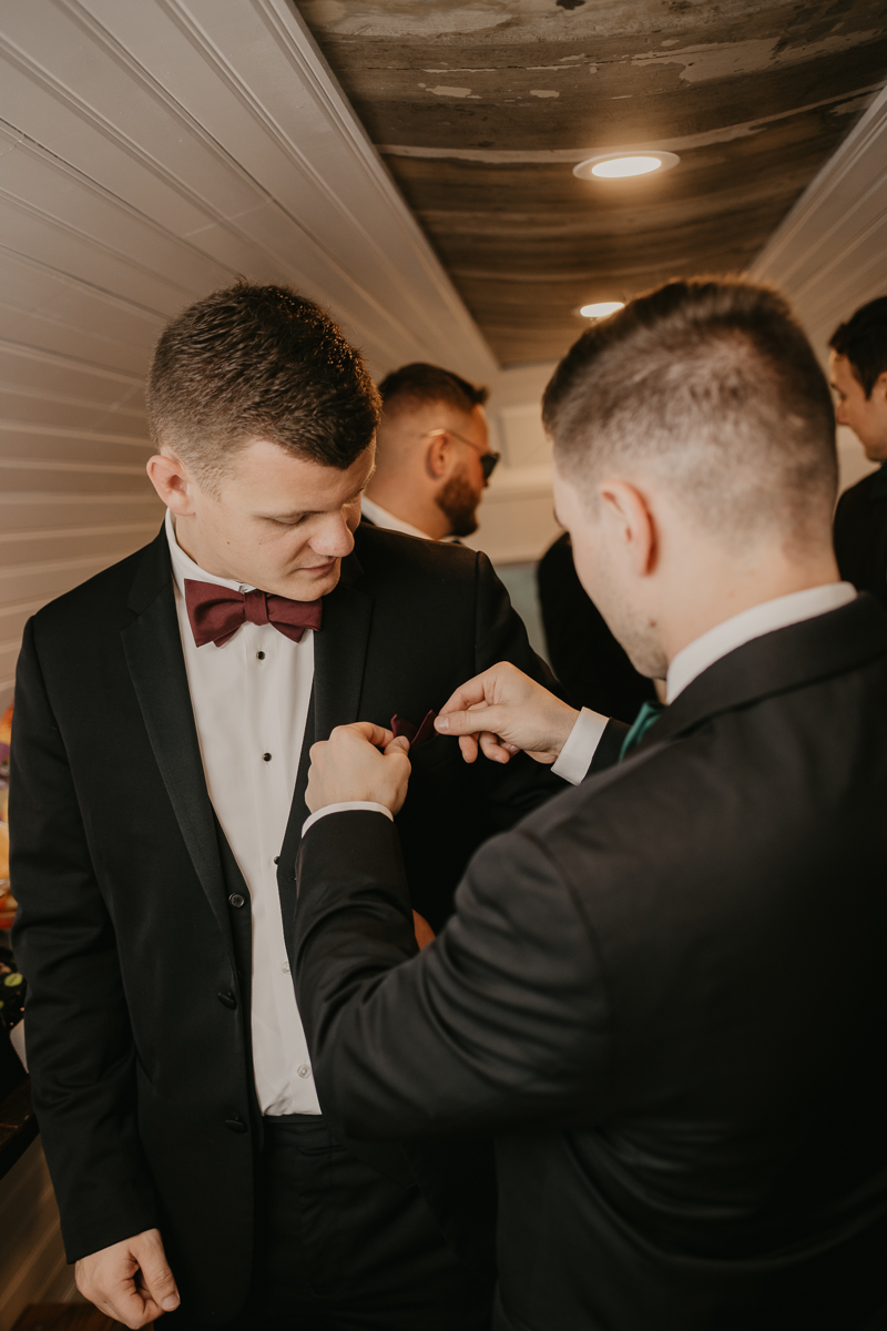 A groom getting ready for his wedding at Kylan Barn in Delmar, Maryland by Britney Clause Photography